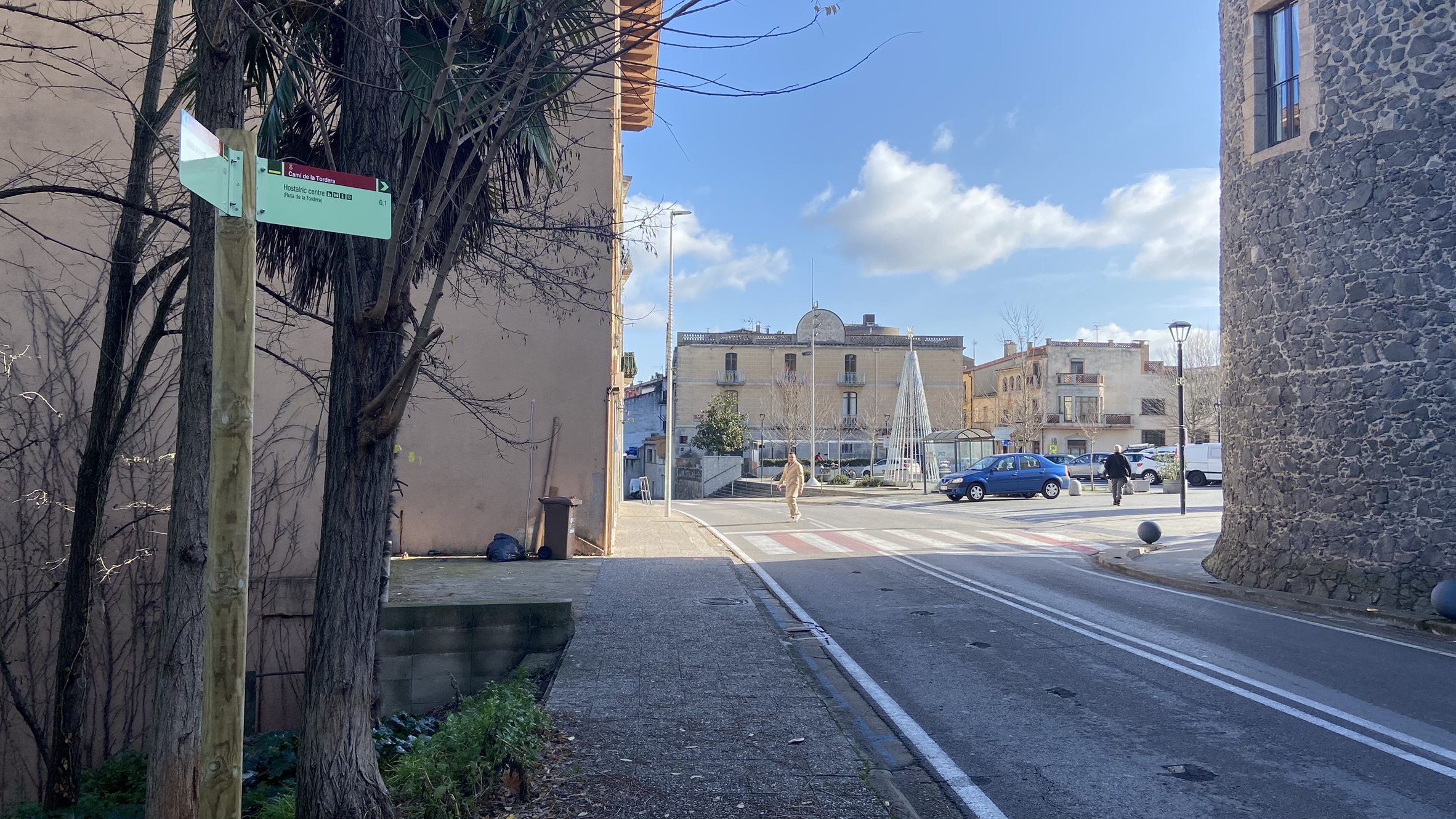 Foto: Tourdera. Senyalització entre l'estació de tren d'Hostalric i la Plaça dels Bous.